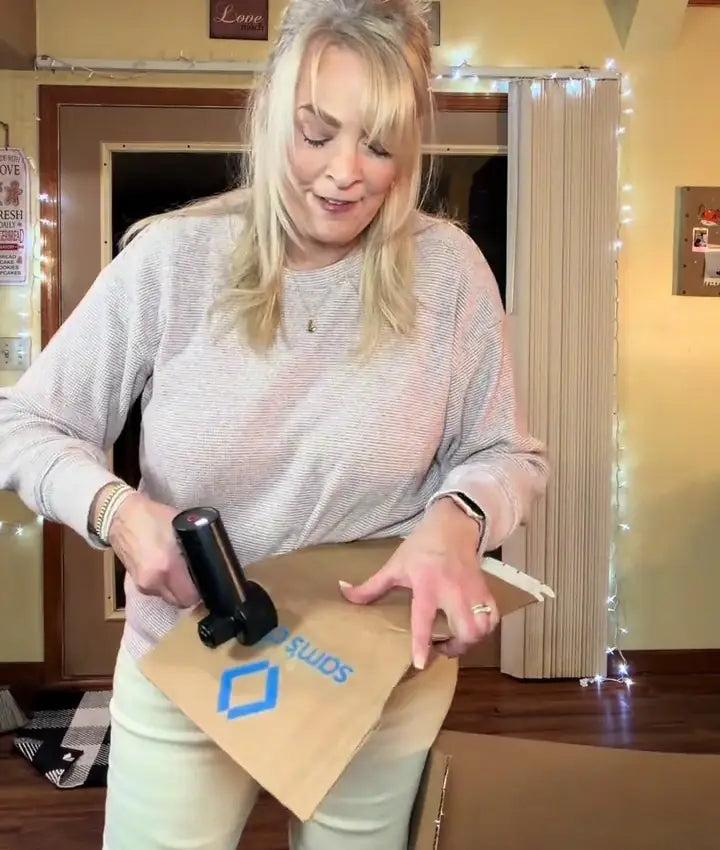 Guarded electric cutter cutting cardboard